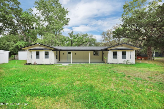 view of front of house featuring an attached carport, a patio, and a front lawn