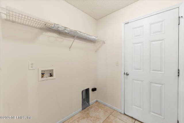 laundry area featuring laundry area, a textured ceiling, light tile patterned floors, baseboards, and hookup for a washing machine