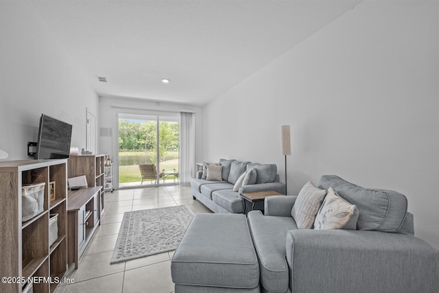 living room with light tile patterned floors and visible vents