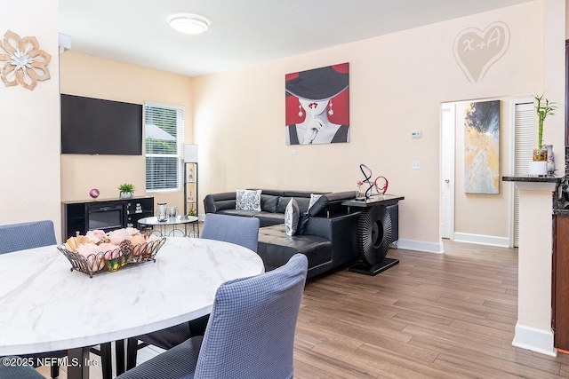 dining room with baseboards and wood finished floors