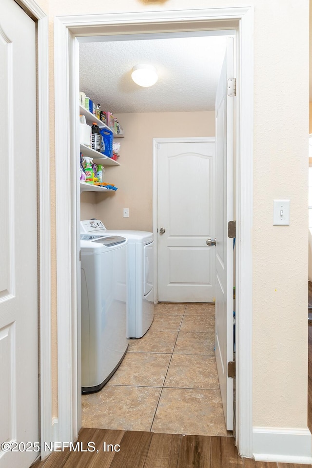 laundry room with light tile patterned floors, laundry area, and washer and clothes dryer
