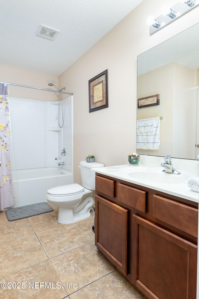 bathroom featuring visible vents, tile patterned flooring, shower / tub combo, vanity, and toilet
