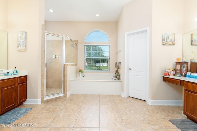 bathroom featuring vanity, a bath, a stall shower, and tile patterned flooring