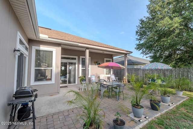 view of patio / terrace with grilling area, fence, and outdoor dining area