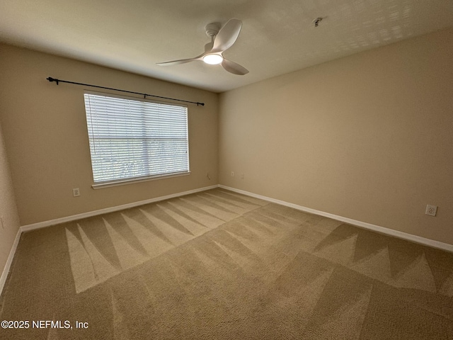 unfurnished room featuring baseboards, carpet flooring, and ceiling fan