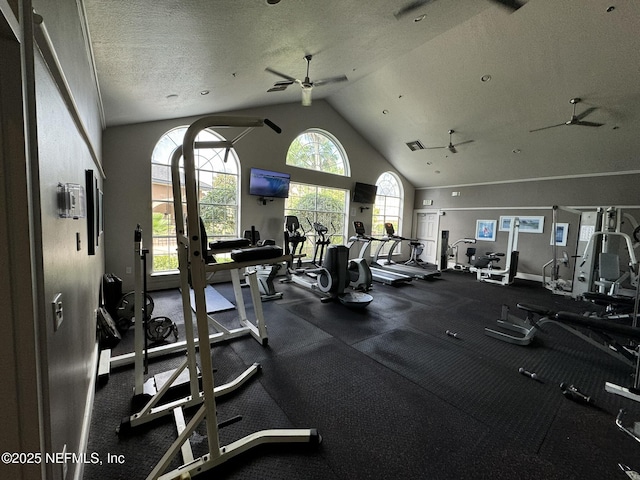 exercise room with visible vents, baseboards, ceiling fan, a textured ceiling, and vaulted ceiling