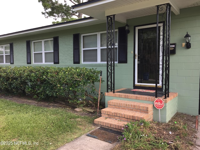 property entrance with brick siding and concrete block siding