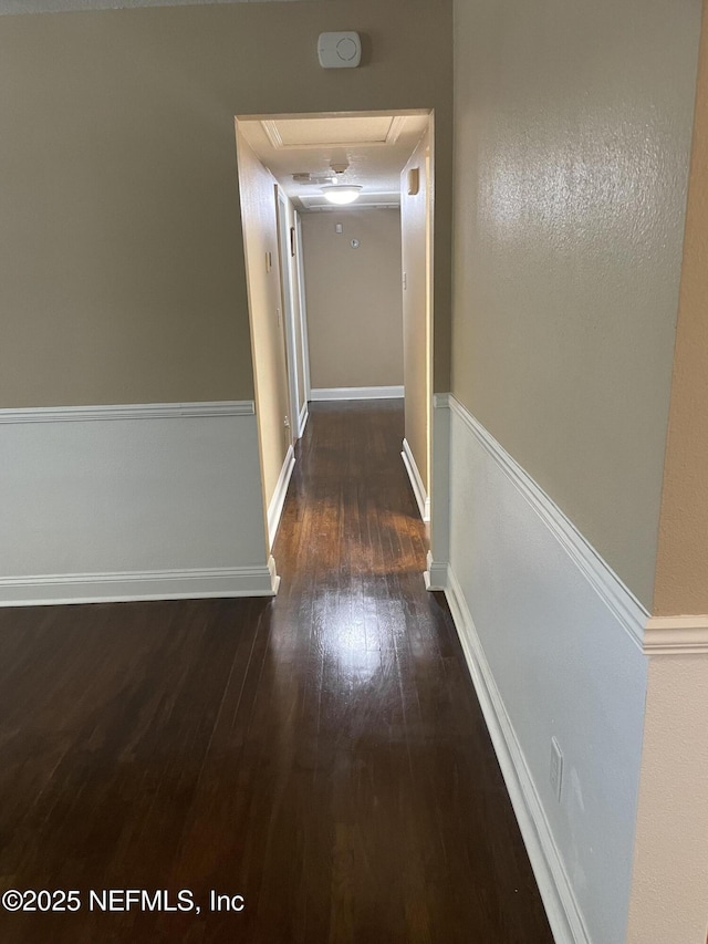 6938 Corkwood Rd, Jacksonville, FL 32277 - corridor with attic access, hardwood / wood-style floors, and baseboards