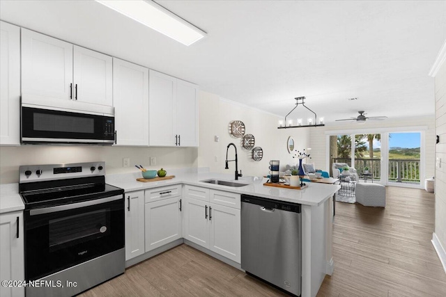 3385 Coastal Hwy Unit 23, Saint Augustine, FL 32084 - kitchen with appliances with stainless steel finishes, a sink, light countertops, a peninsula, and open floor plan