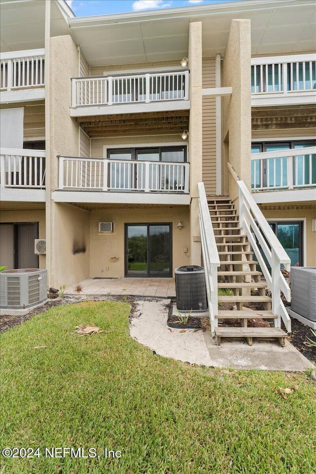 3385 Coastal Hwy Unit 23, Saint Augustine, FL 32084 - exterior space with central AC, stairs, and stucco siding