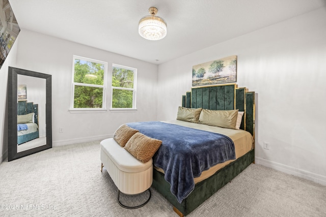 carpeted bedroom with baseboards