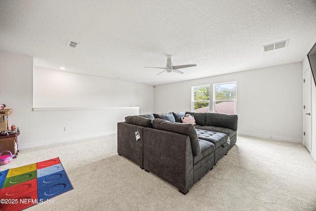 living room featuring baseboards, a ceiling fan, light colored carpet, and visible vents