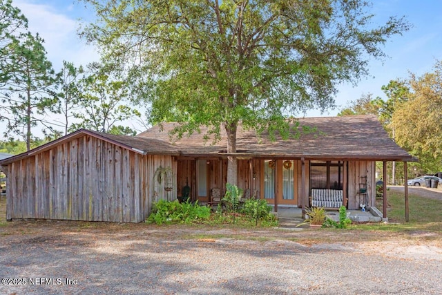 view of front facade featuring covered porch and board and batten siding