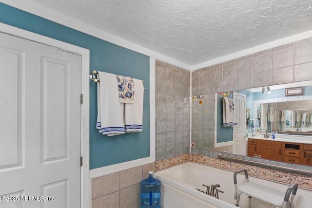 bathroom with a garden tub, vanity, wainscoting, tile walls, and a textured ceiling