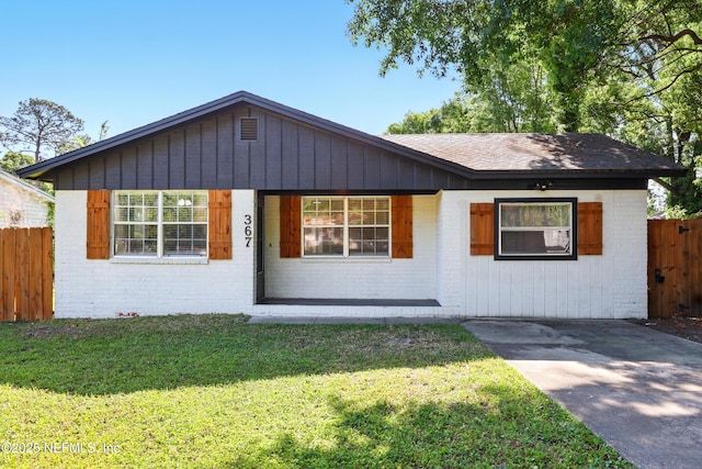 367 Orange Ave, Baldwin, FL 32234 - view of front of house with covered porch, brick siding, fence, and a front yard