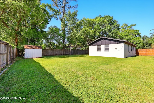 367 Orange Ave, Baldwin, FL 32234 - view of yard with a fenced backyard, an outbuilding, and a storage shed