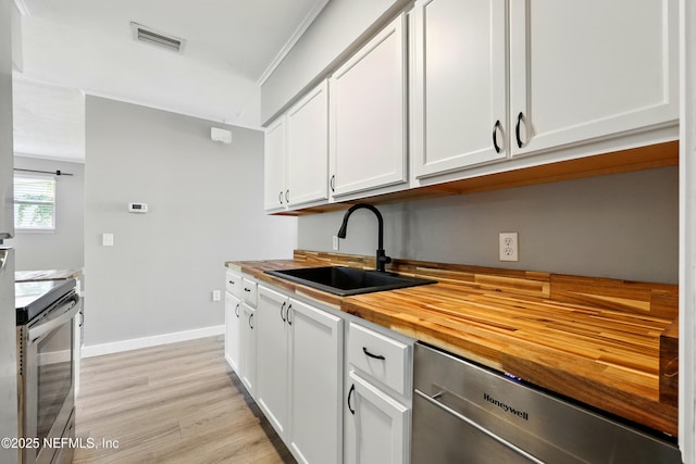 367 Orange Ave, Baldwin, FL 32234 - kitchen with visible vents, butcher block countertops, a sink, light wood-style flooring, and stainless steel appliances