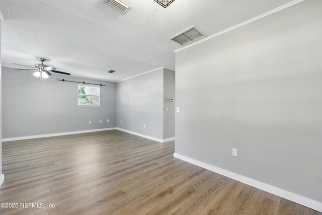 367 Orange Ave, Baldwin, FL 32234 - unfurnished room with baseboards, ceiling fan, wood finished floors, and visible vents