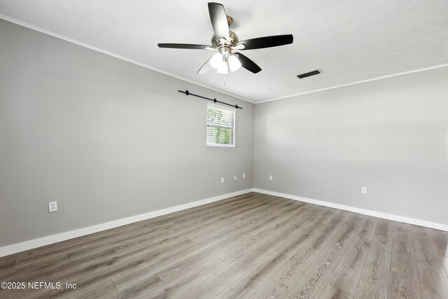 367 Orange Ave, Baldwin, FL 32234 - spare room with crown molding, ceiling fan, baseboards, wood finished floors, and visible vents