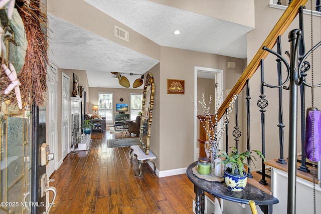 50 Jefferson Ave, Ponte Vedra Beach, FL 32082 - foyer featuring a textured ceiling, baseboards, visible vents, stairs, and dark wood-type flooring
