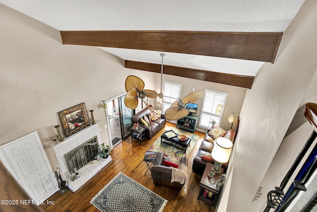 50 Jefferson Ave, Ponte Vedra Beach, FL 32082 - living room featuring a textured ceiling, hardwood / wood-style floors, a fireplace with raised hearth, and vaulted ceiling with beams