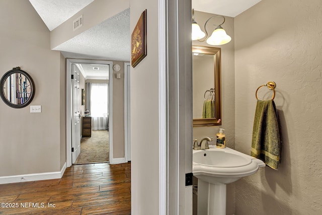 50 Jefferson Ave, Ponte Vedra Beach, FL 32082 - bathroom with hardwood / wood-style floors, a textured ceiling, visible vents, baseboards, and a textured wall
