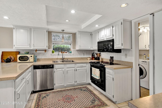 50 Jefferson Ave, Ponte Vedra Beach, FL 32082 - kitchen featuring washer / dryer, light tile patterned flooring, black appliances, and a sink