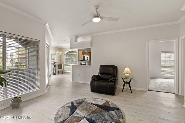 10961 Burnt Mill Rd Unit 318, Jacksonville, FL 32256 - sitting room featuring baseboards, ornamental molding, ceiling fan with notable chandelier, and light wood-type flooring