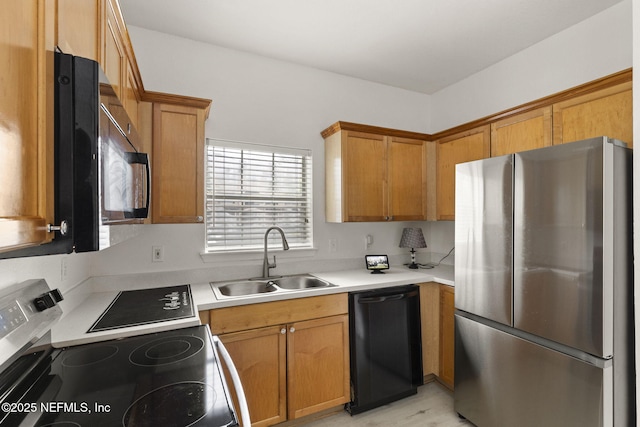 10961 Burnt Mill Rd Unit 318, Jacksonville, FL 32256 - kitchen featuring a sink, brown cabinets, black appliances, and light countertops