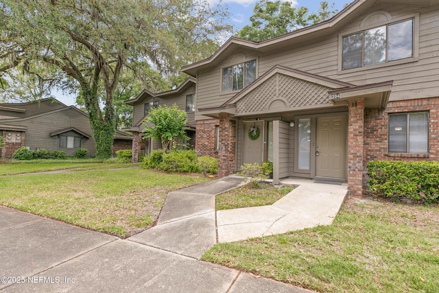 1909 University Blvd S Unit 204, Jacksonville, FL 32216 - view of front of home featuring a front lawn and brick siding