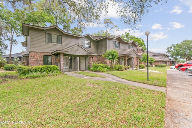 1909 University Blvd S Unit 204, Jacksonville, FL 32216 - view of front facade with brick siding and a front yard