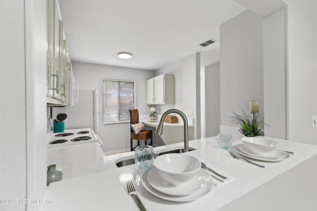 1909 University Blvd S Unit 204, Jacksonville, FL 32216 - interior space featuring a sink, a peninsula, white microwave, visible vents, and light countertops