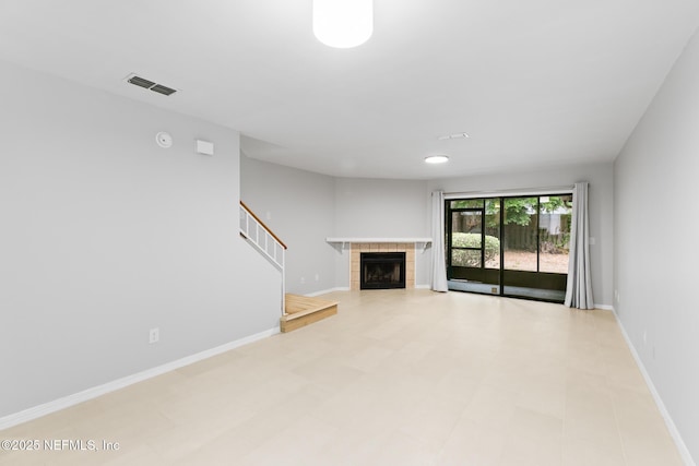 1909 University Blvd S Unit 204, Jacksonville, FL 32216 - unfurnished living room with a fireplace, stairs, baseboards, and visible vents
