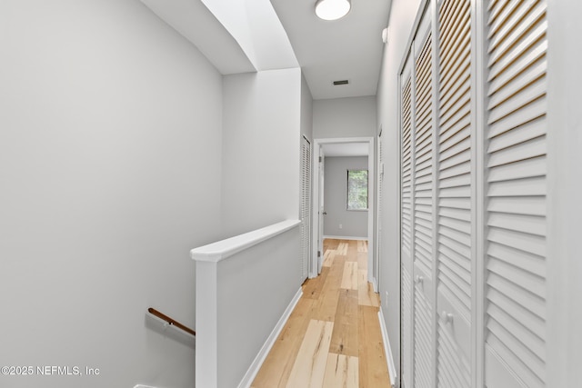 1909 University Blvd S Unit 204, Jacksonville, FL 32216 - hallway featuring baseboards, light wood finished floors, and an upstairs landing