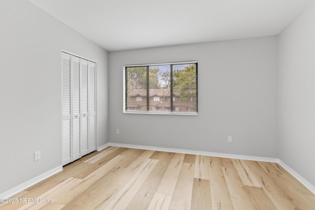1909 University Blvd S Unit 204, Jacksonville, FL 32216 - unfurnished bedroom with a closet, wood finished floors, and baseboards