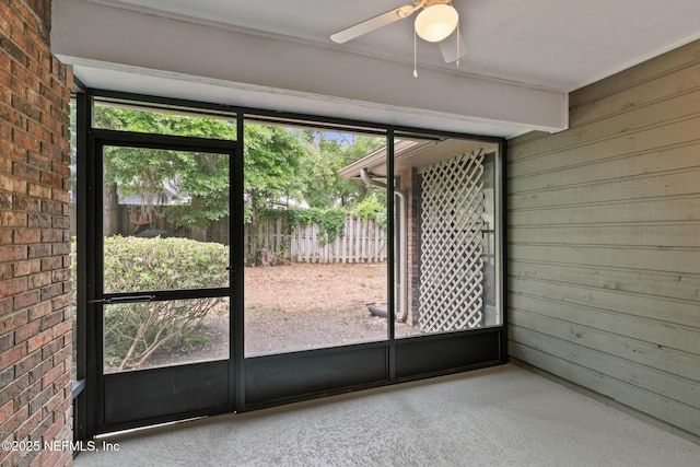 1909 University Blvd S Unit 204, Jacksonville, FL 32216 - interior space featuring wood walls, ceiling fan, and brick wall