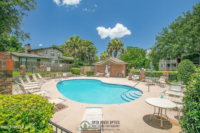 1909 University Blvd S Unit 204, Jacksonville, FL 32216 - community pool featuring a patio and fence