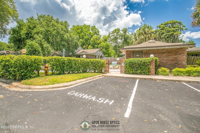 1909 University Blvd S Unit 204, Jacksonville, FL 32216 - uncovered parking lot with a gate and fence