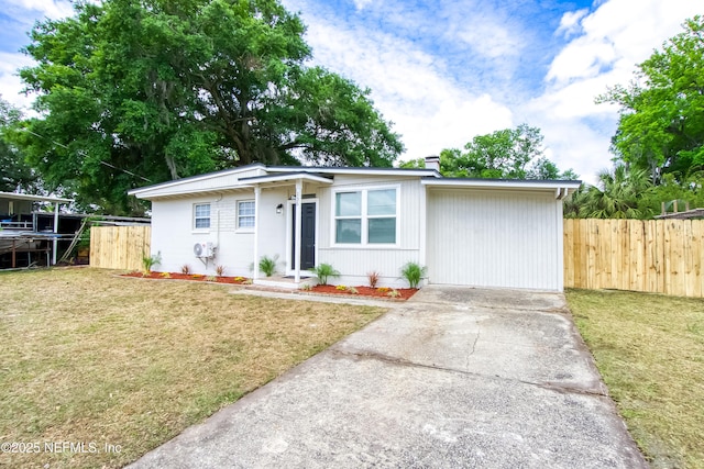 ranch-style home with a chimney, fence, driveway, and a front yard