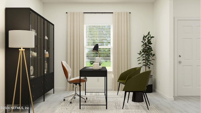 office area with light wood-style floors and baseboards