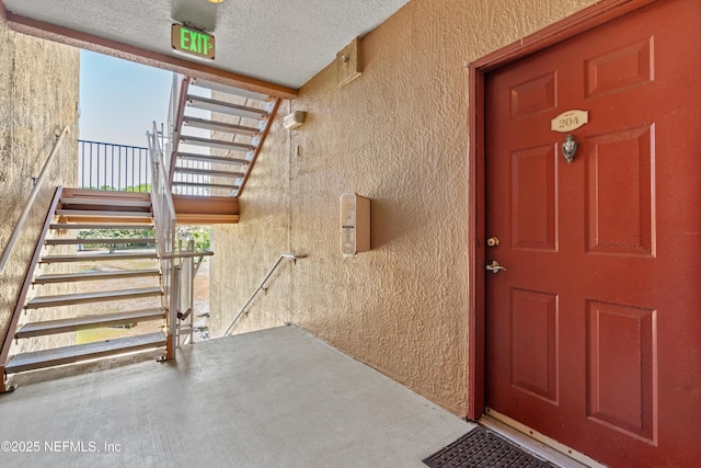 property entrance with stucco siding