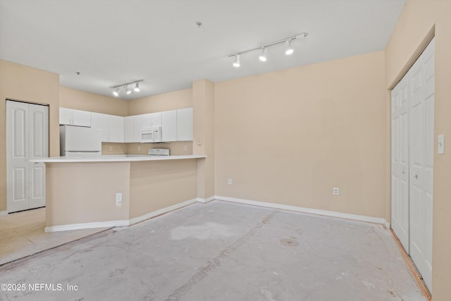 kitchen featuring a peninsula, white appliances, baseboards, light countertops, and white cabinets