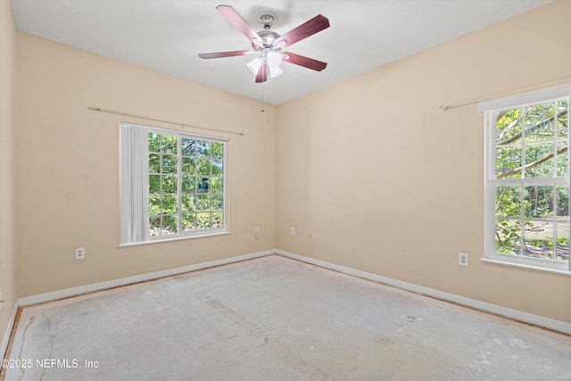 unfurnished room featuring baseboards, ceiling fan, and a wealth of natural light
