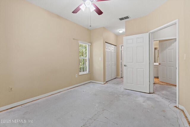 unfurnished bedroom featuring baseboards, a closet, concrete floors, and visible vents