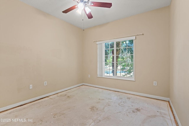 empty room with baseboards and a ceiling fan