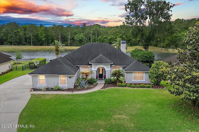 185 Edgewater Branch Dr, Saint Johns, FL 32259 - single story home featuring stucco siding, a chimney, concrete driveway, a water view, and a yard