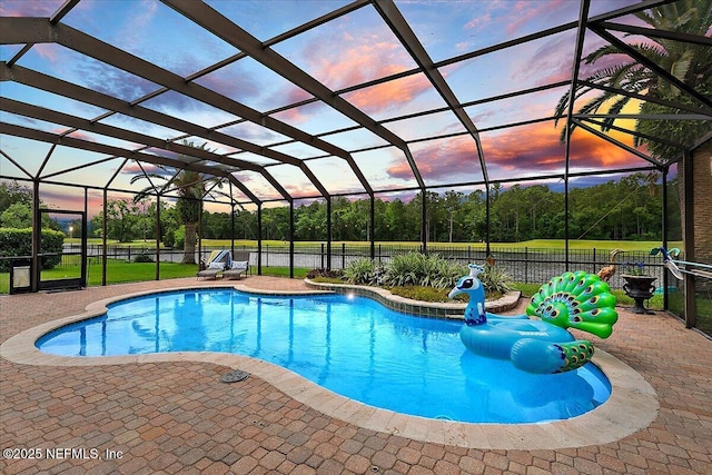 185 Edgewater Branch Dr, Saint Johns, FL 32259 - pool at dusk featuring a fenced in pool, glass enclosure, a patio area, and fence