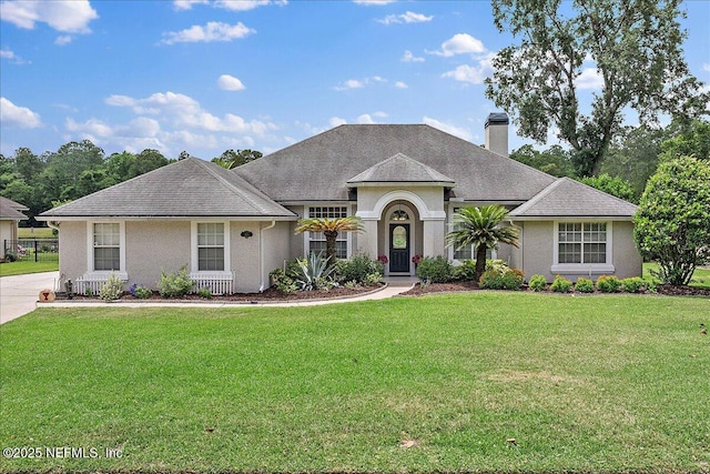 185 Edgewater Branch Dr, Saint Johns, FL 32259 - ranch-style home with a chimney, stucco siding, and a front lawn