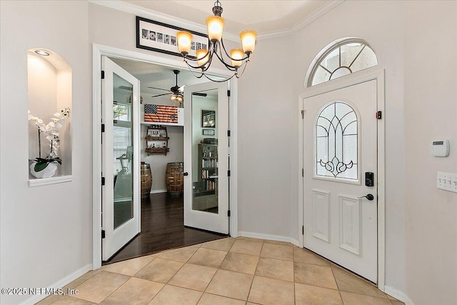 185 Edgewater Branch Dr, Saint Johns, FL 32259 - entryway with baseboards, crown molding, ceiling fan with notable chandelier, and light tile patterned floors