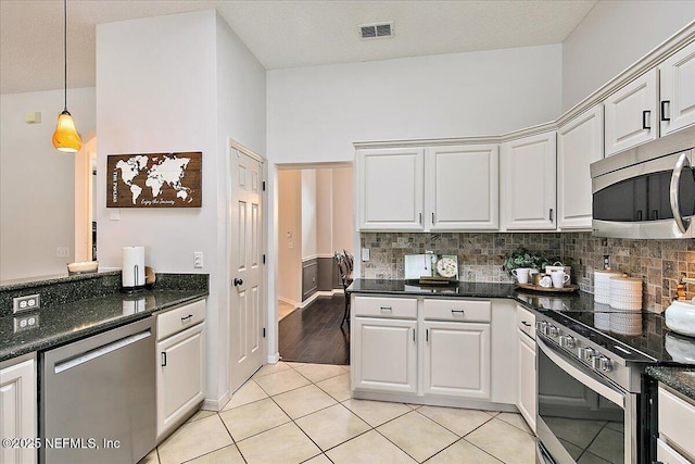 185 Edgewater Branch Dr, Saint Johns, FL 32259 - kitchen featuring appliances with stainless steel finishes, white cabinets, tasteful backsplash, and visible vents